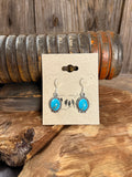 Turquoise oval fishhook earrings with silver beaded bezel and dangling hooks