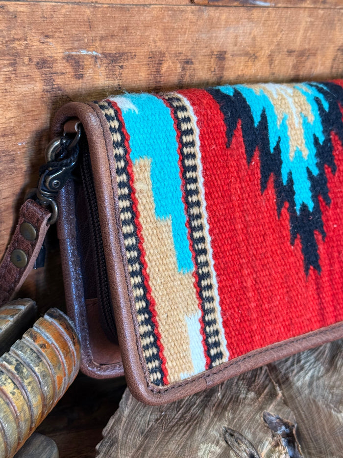 Woven crossbody wristlet wallet with multicolor stripe fabric and brown leather trim, wrist strap
