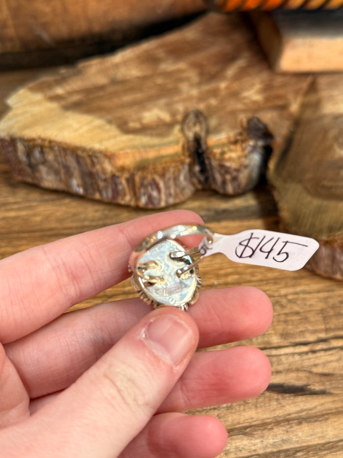 Sterling silver ring with oval turquoise gemstone and visible underside hallmarks