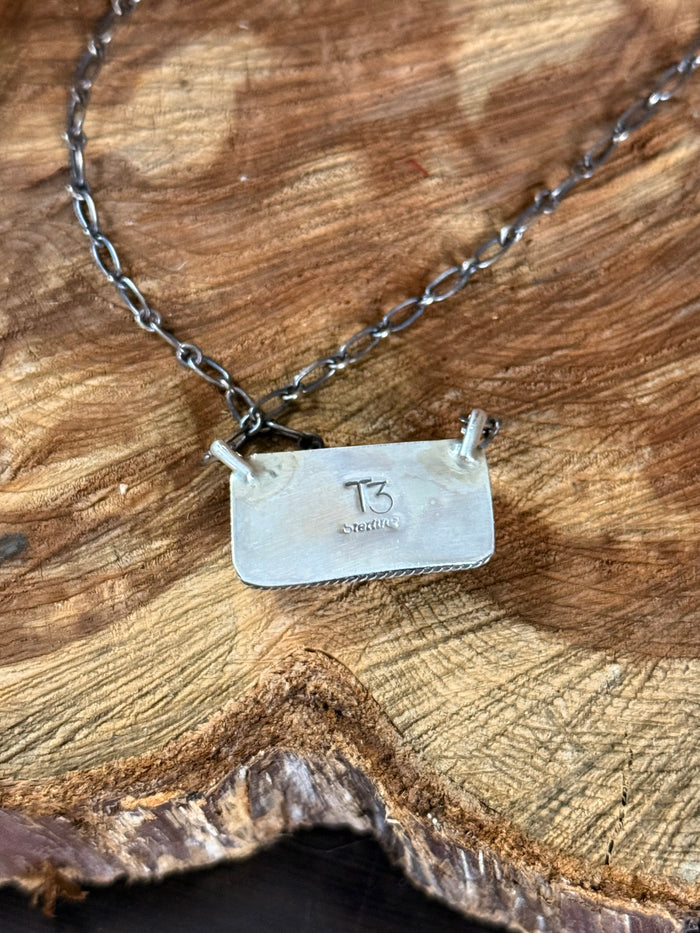Sterling silver necklace with rectangular pendant stamped T3 on back, link chain