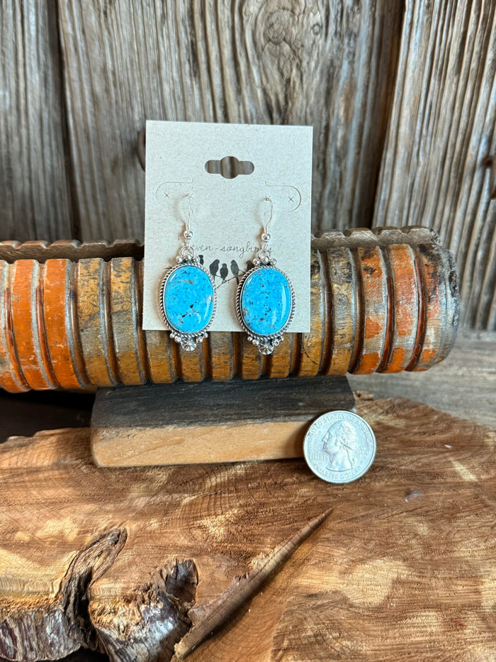 Turquoise oval fishhook earrings with silver scalloped frame and dangling beads