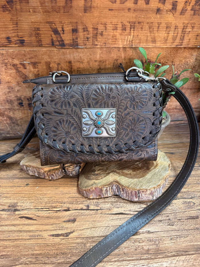 Dark brown crossbody purse with embossed floral flap and turquoise/silver buckle clasp