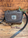 Dark brown crossbody purse with embossed floral flap and turquoise/silver buckle clasp
