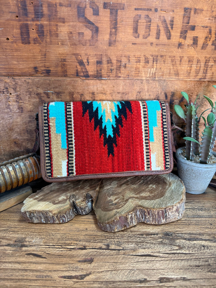 Woven crossbody wristlet wallet with red, turquoise, and black zigzag pattern and zipper