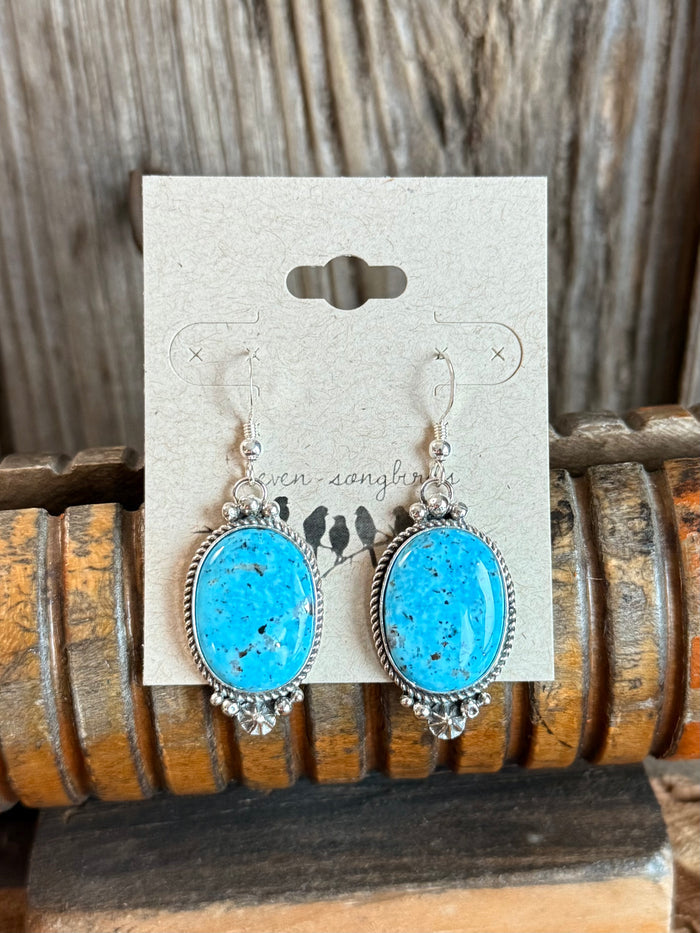 Turquoise oval fishhook earrings with silver bead and floral frame