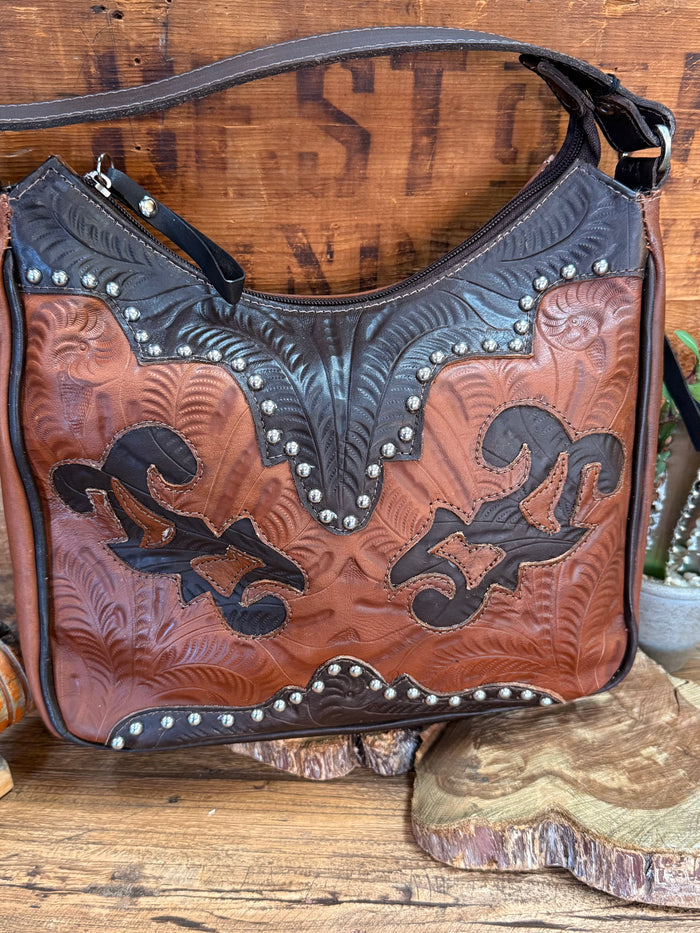 Leather hobo bag in brown and chocolate with floral tooling, stud trim, black top