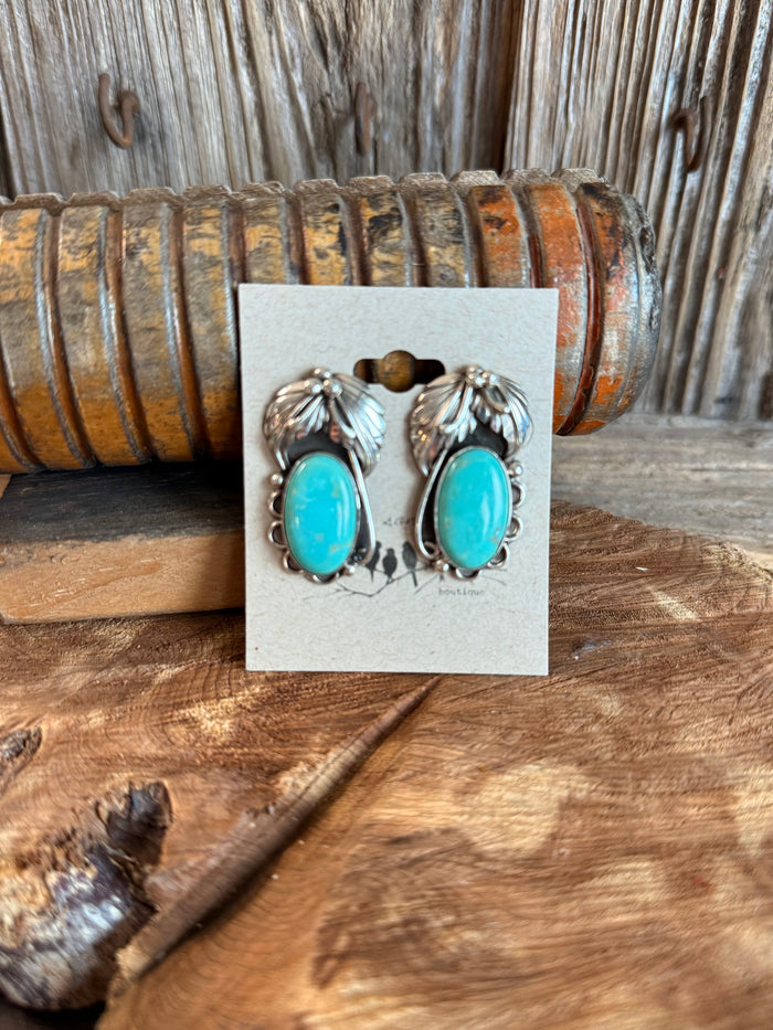 Turquoise oval stud earrings with sterling silver feathered bezel settings