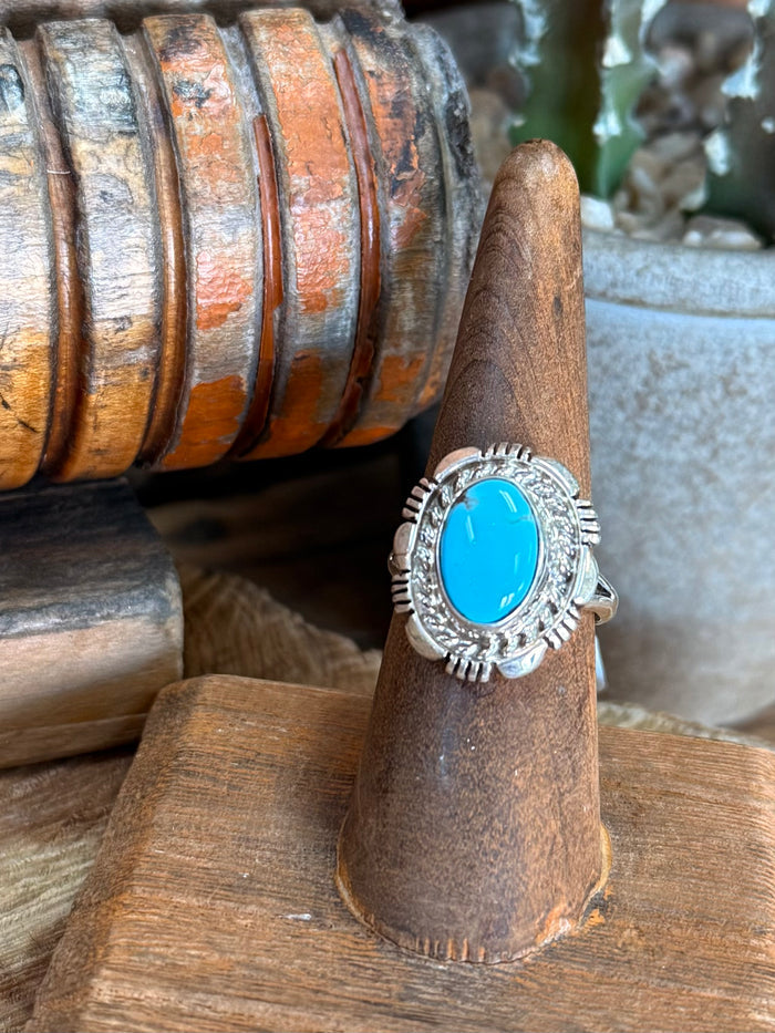 Sterling silver turquoise oval ring with scalloped bezel and ridged side accents