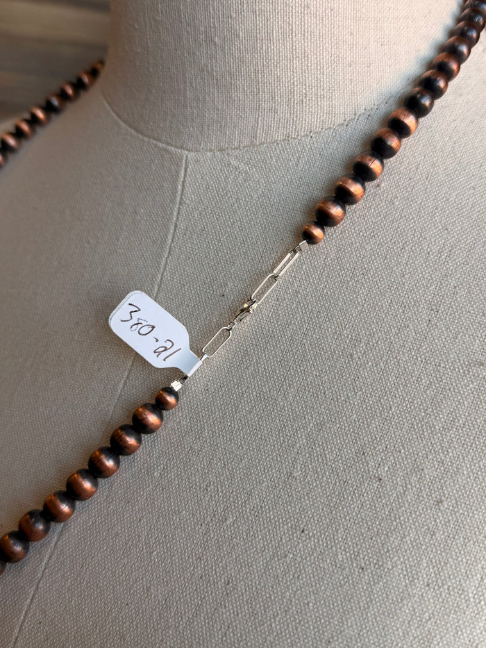 Copper bead necklace with toggle clasp and attached tag