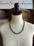Beaded turquoise and copper bead necklace with round beads on a mannequin bust