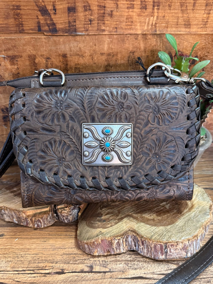 Dark brown crossbody purse, embossed floral front with turquoise center accents on flap