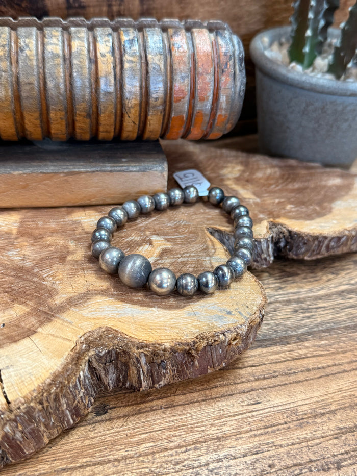 Sterling stretch bead bracelet with gray round beads and a larger center bead