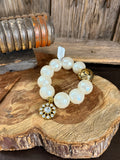 Pearl gold crystal charm stretch bracelet with round white opal beads and floral charm