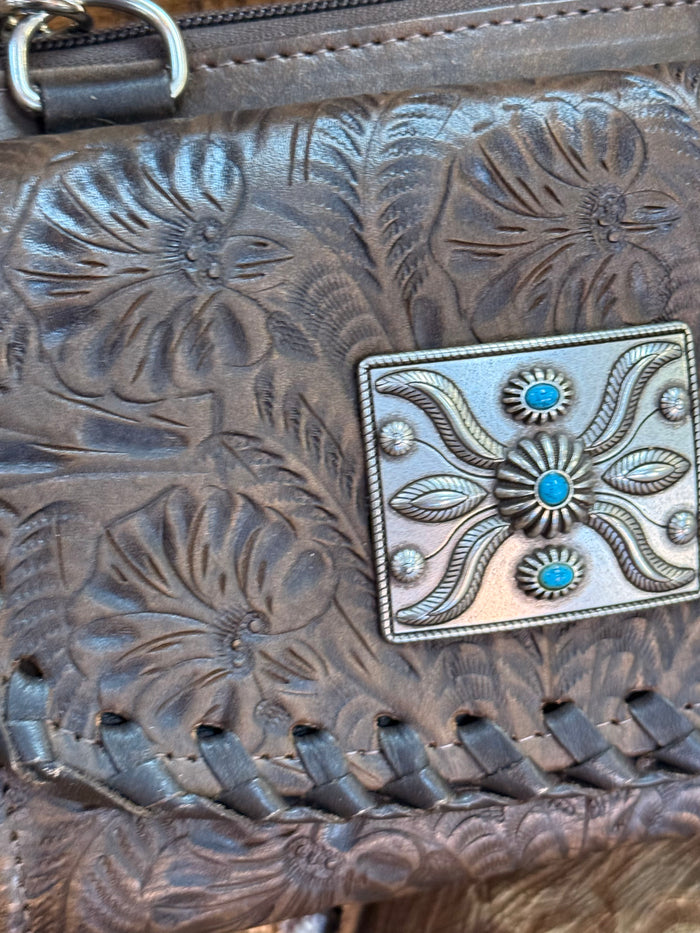 Turquoise-silver buckle detail on embossed dark brown leather crossbody flap