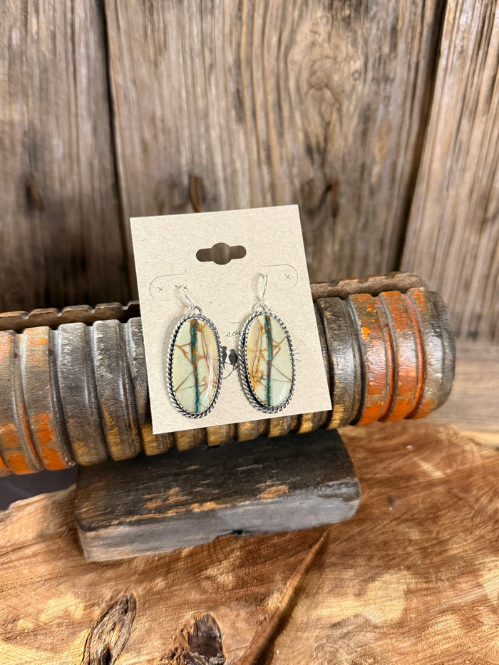 Silver fishhook earrings with oval turquoise ribbon stone dangles in beaded frame