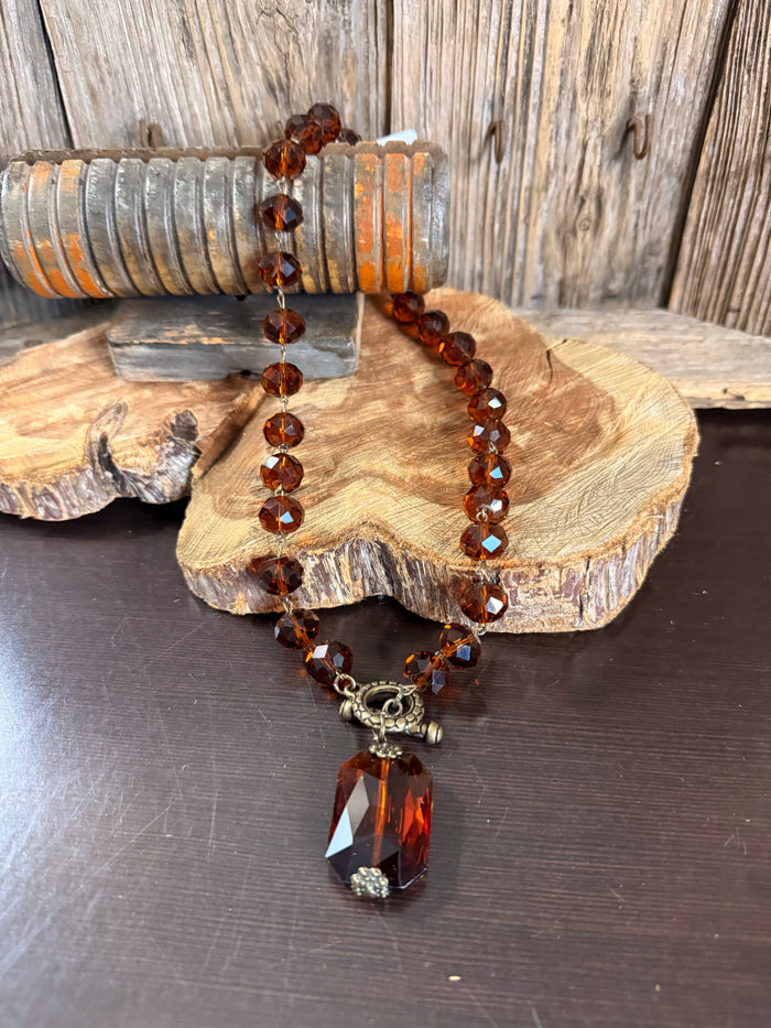 Amber crystal bead necklace with large faceted pendant and metal charm