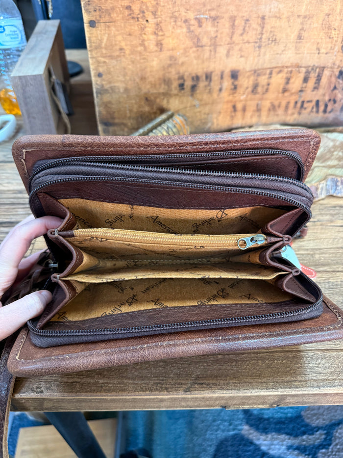 Dark brown woven crossbody wristlet wallet, open with zip compartments and wrist strap