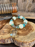 Stretch charm bracelet with opal-like pearl beads, turquoise accents, faceted crystal charm