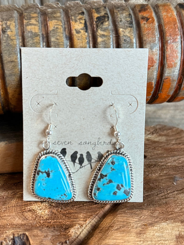 Sterling silver fishhook earrings with turquoise teardrop stones, scalloped bezels