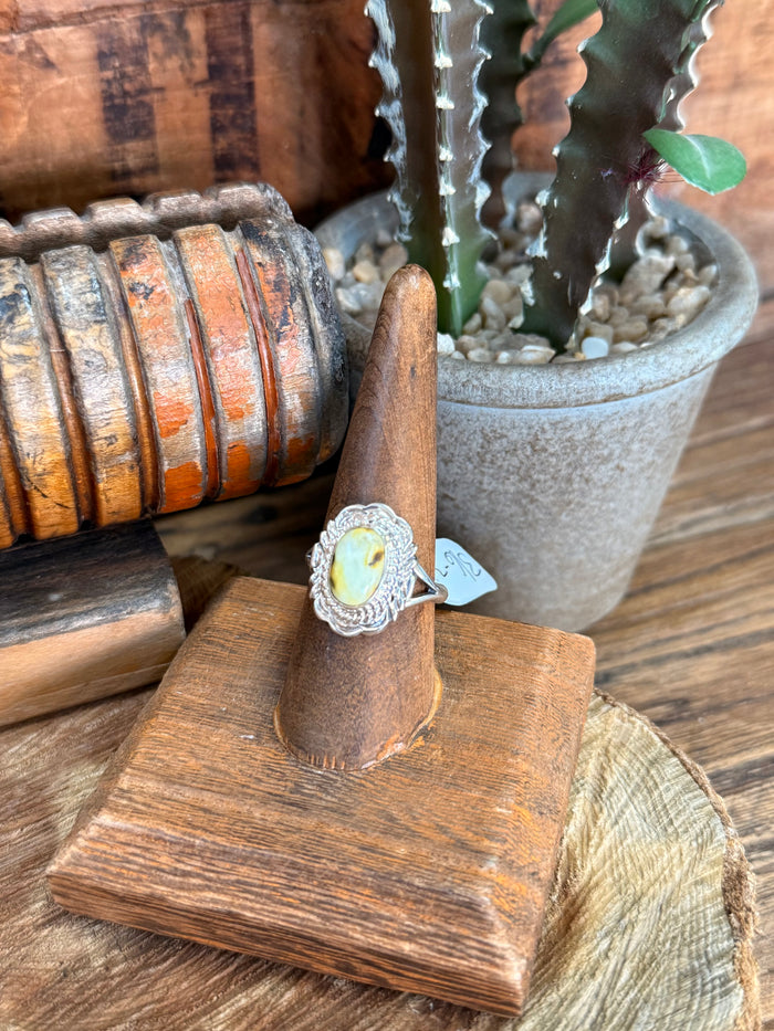 Sterling silver ring with oval pale yellow center stone and rope-detail bezel