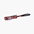 A red and black EzyDog Beaver Tail dog toy made of rope on white background