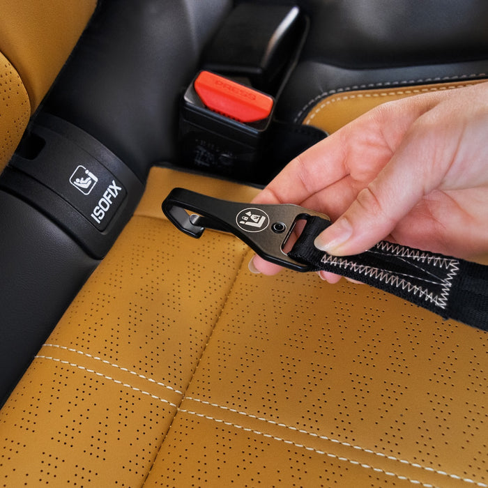 Hand adjusting a car seat belt buckle on a brown car seat.