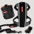 Dog training equipment including a harness, leash, and clicker on a light gray background.