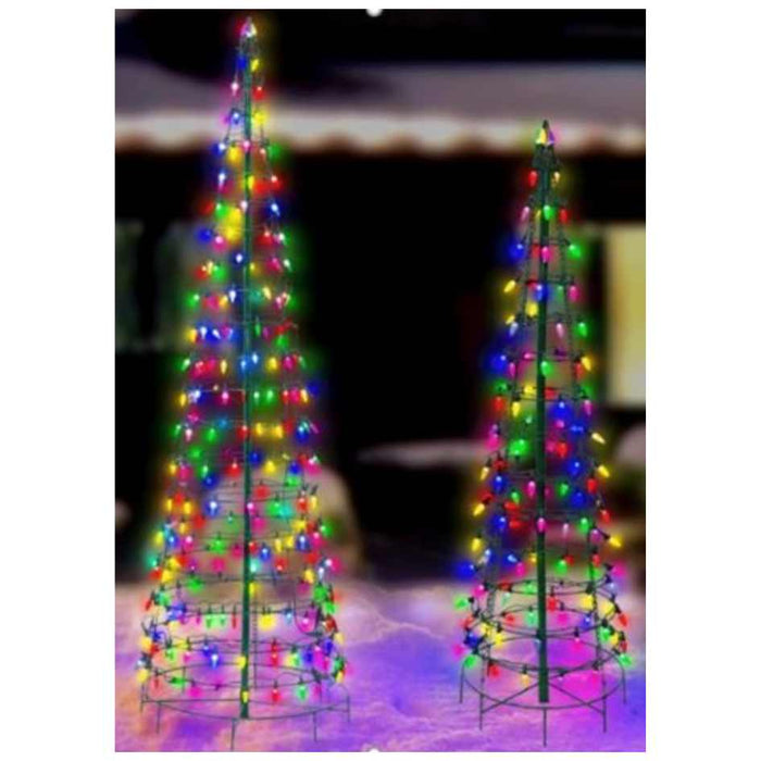 The 4' Cone Tree LED Outdoor Decor from Available for Pick-Up & Delivery features a wire frame illuminated in red, green, yellow, and blue, glowing brightly on a snowy surface with a softly lit building blurred in the background.