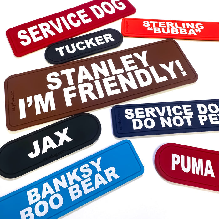 Collection of personalized dog name tags in various colors and text.