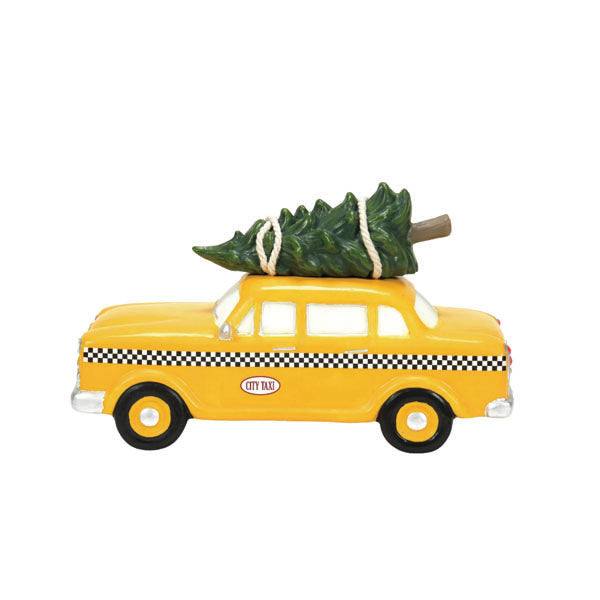 The Department 56 – Hailing Christmas Cab by Available for Pick-up & Delivery is a ceramic yellow taxi model with black checkered details, featuring a green Christmas tree on its roof and “City Taxi” emblems, perfect for a festive figurine collection.