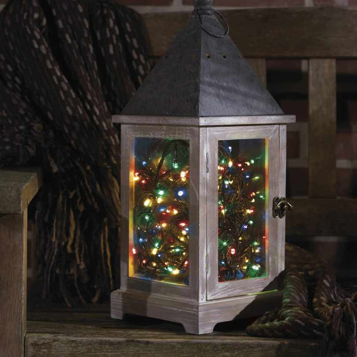 The Durawise Battery Operated LED Twinkle String Lights Multi-Colored from Available for Pickup & Delivery fill a rustic lantern, creating a festive, cozy atmosphere both indoors and outdoors.