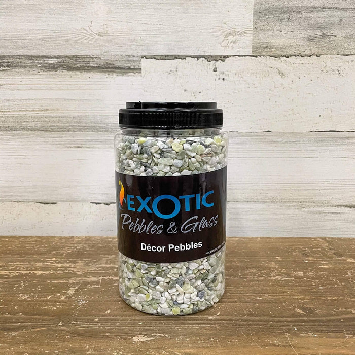 A 5-lb. plastic jar of Exotic Pebbles - Jade Bean Pebbles from Available for Pickup & Delivery sits on a wooden surface, filled with small mixed-color decorative stones against a rustic light wood plank background.