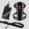 Black and gray dog harness with red label on a light gray background