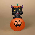 The Inflatable - Cat in Jack-o-Lantern by Available for Pick-up & Delivery features a cheerful black cat with a pumpkin hat perched on a glowing orange jack-o-lantern, set against a plain beige background—a perfect Halloween decoration.