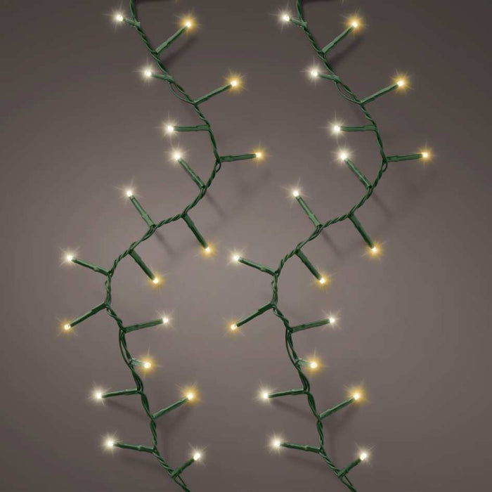 Two strands of LED 1000 ct. Compact String Lights in warm white and cool white, with green wiring, are displayed vertically against a gray background—an ideal festive accent for your holiday décor. Available for Pick-Up & Delivery.