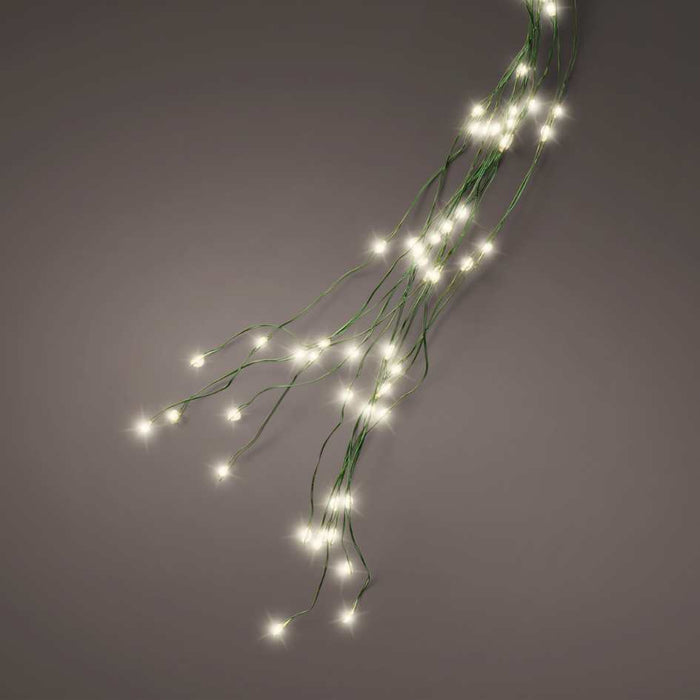 Thin green wires with small warm white LED lights are arranged loosely against a plain grey background, resembling the cascading effect of the Micro LED 672 ct. Tree Bunch Warm White by Available for Pick-Up & Delivery.