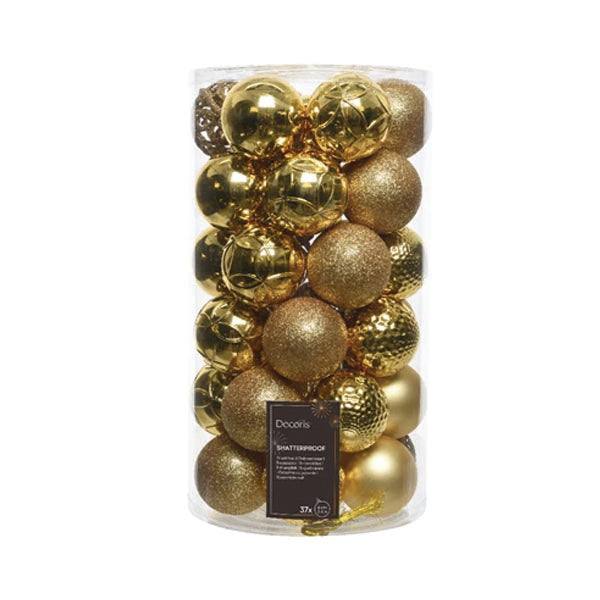 A clear cylindrical container with 37 gold ornaments includes shiny, matte, and glitter finishes for holiday décor. Ideal for tree trimming, the label reads Available for Pick-Up & Delivery and Shatterproof.
