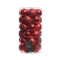 A clear cylindrical container filled with red, shatterproof ornaments—ideal for tree trimming. They feature shiny, glittery, and matte textures. The label shows Ornaments – Shatterproof - Red by Available for Pick-Up & Delivery, making it a perfect holiday décor piece.
