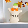 Plush Otto stuffed animal on a ledge.