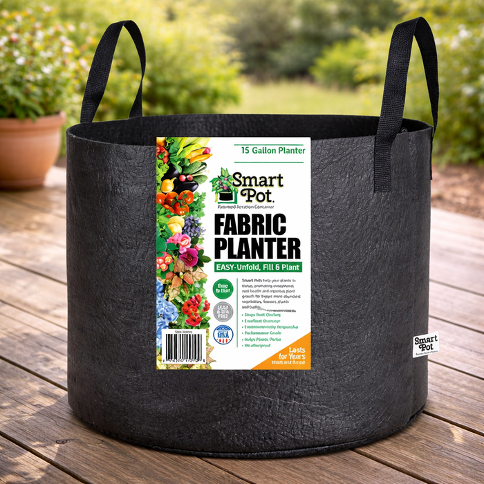 A 15-gallon Planter - Smart Pot with Handle by Pickup & Local Delivery Only sits outdoors on wood, featuring a label with vibrant vegetables and flowers and showcasing its breathable fabric design.