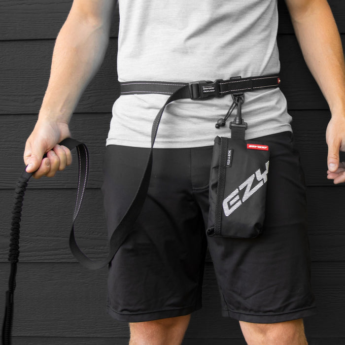 Person wearing a black waist bag with 'EZY' branding against a dark background