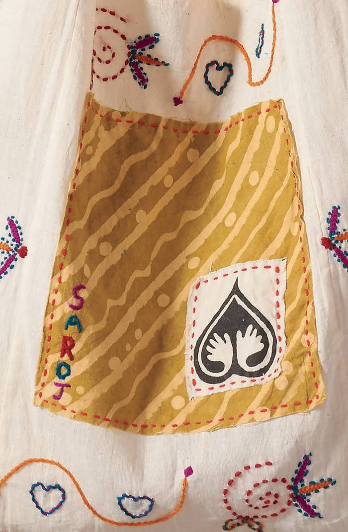 Yellow apron with embroidered designs and 'SARON' branding on a white background