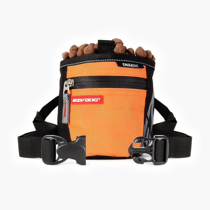 Orange dog treat bag with a black strap and brown treats on a white background