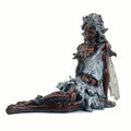 The Statuary - Fairy Sitting with Bird by Pick-Up & Local Delivery Only is a bronze-finished resin statue featuring a seated fairy with long hair, pointed ears, delicate wings, nature accents, and a thoughtful look.