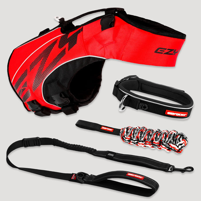 Red and black dog harness, leash, and collar set on a light gray background