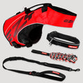 Red and black dog harness, leash, and collar set on a light gray background