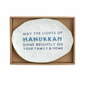 The HANUKKAH TRAY by Available for Pick-Up & Delivery is a white ceramic tray with embossed Stars of David and “May the lights of Hanukkah shine brightly on your family & home,” boxed for gifting—ideal festive décor.