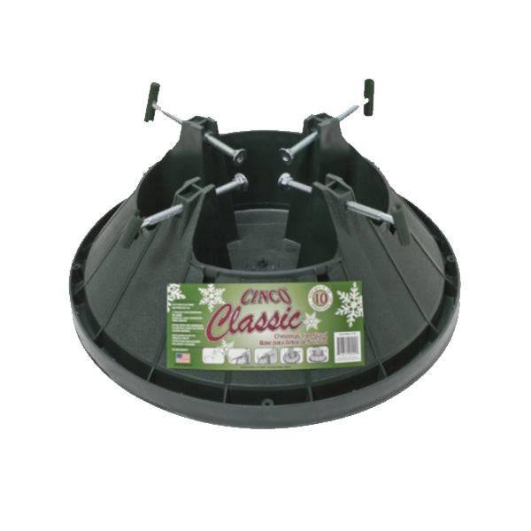 A green plastic tree stand labeled Tree Stand - Never Fail - Up to 12 ft. Trees by All Delivery Options features a spill guard, four metal screws, a central opening, and a festive sticker with snowflakes and care instructions.