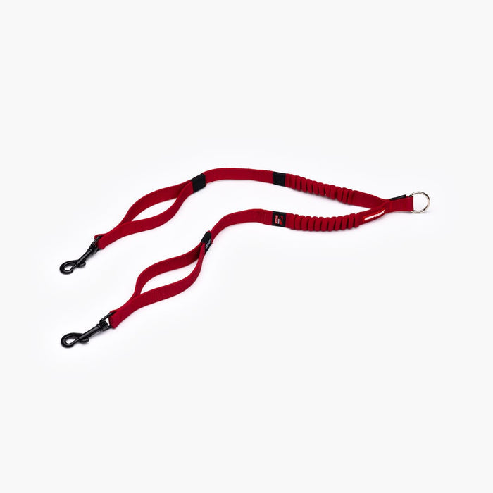 A red Zero Shock Couplers leash with a tangle-free traffic handle and proprietary super soft webbing.