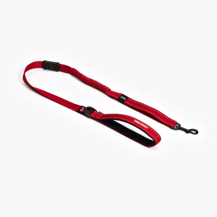 A red Zero Shock leash designed for dogs, on white background